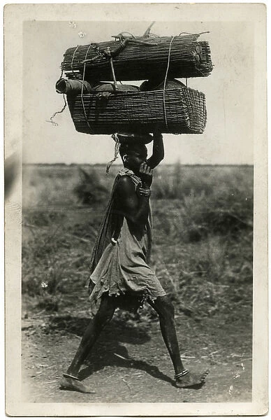 Carrying a heavy load on the head - Sudan