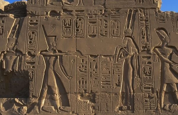 Egyptian Art. Karnak. A pharaoh before a god. Relief