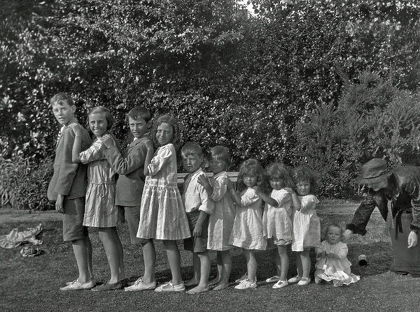 Family of ten children standing in a line