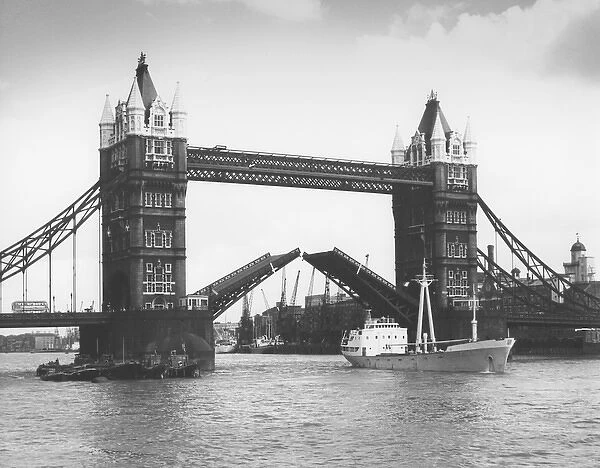 Tower Bridge, London - opening up for cargo vessel to pass u