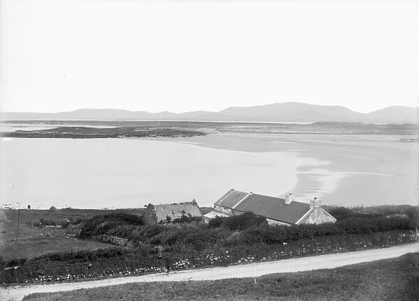 An unidentified coastal view, with cottages