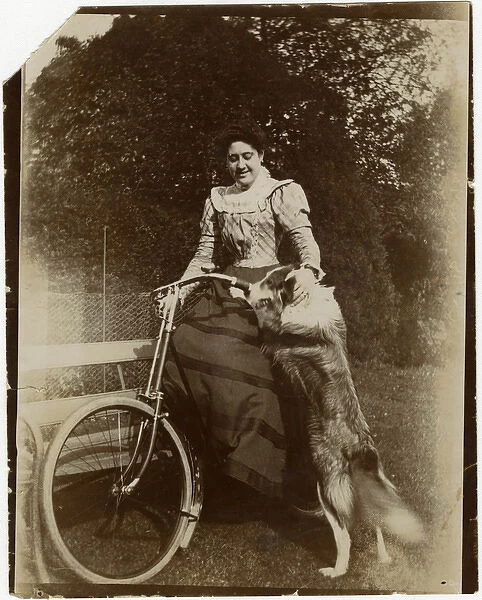Woman with dog and bicycle in a garden