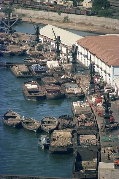 Boats and barges along the waterfront of the docks in Karachi