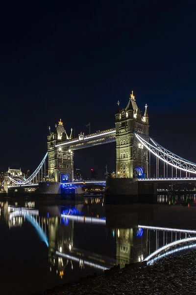 Tower Bridge at night just before sunrise, reflecting in a still River Thames, London, England, United Kingdom, Europe