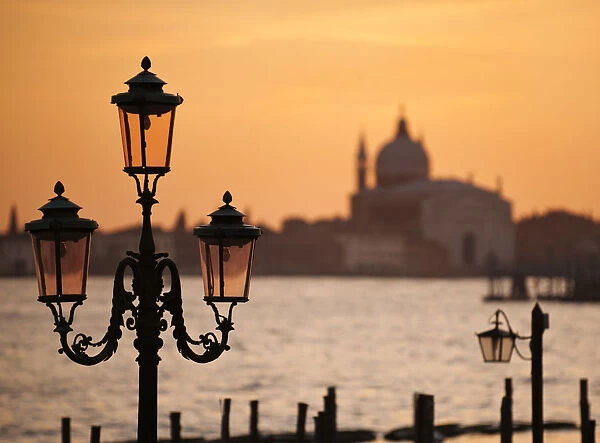 Traditional lamps and The Chiesa del Santissimo Redentore at sunset, Venice, Veneto