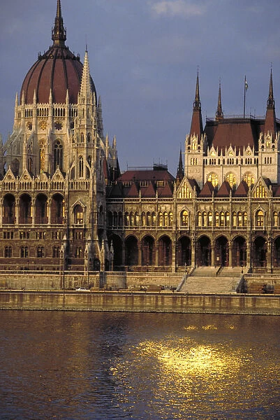 10004918. HUNGARY Budapest Parliament Building at sunset with the sun reflected