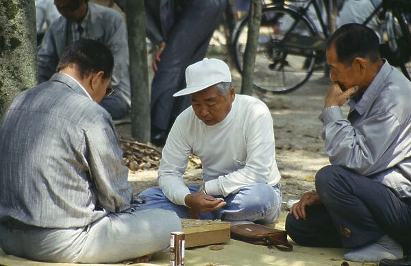 10005621. JAPAN Honshu Hiroshima Men playing game on a mat in the Peace Park