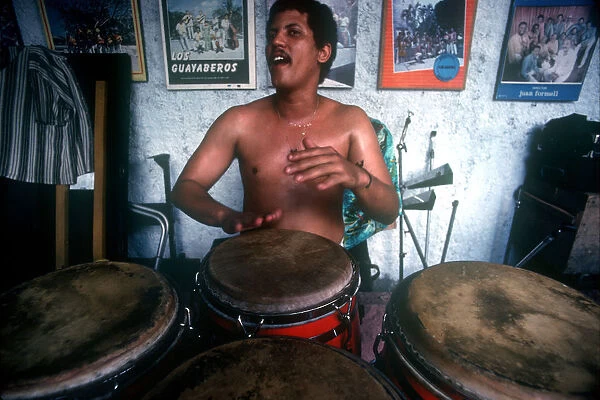 10011497. CUBA Havana Musician playing Bongo Drums
