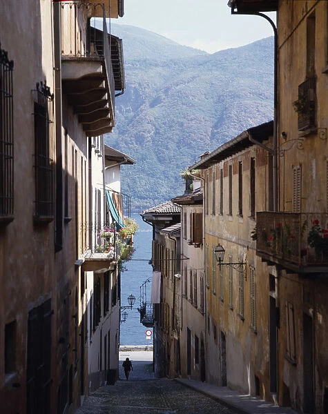 10016168. ITALY Piedmont Lake Maggiore Cannobio. Steep cobbled street leading down to lake