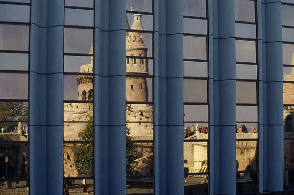 10016647. HUNGARY Budapest Fishermens Bastion reflected in the windows of the Hilton Hotel