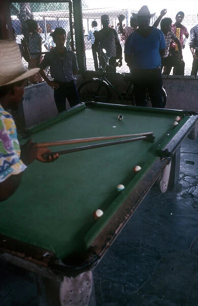 10069487. CUBA Gualmaro Men playing Pool while other men look on