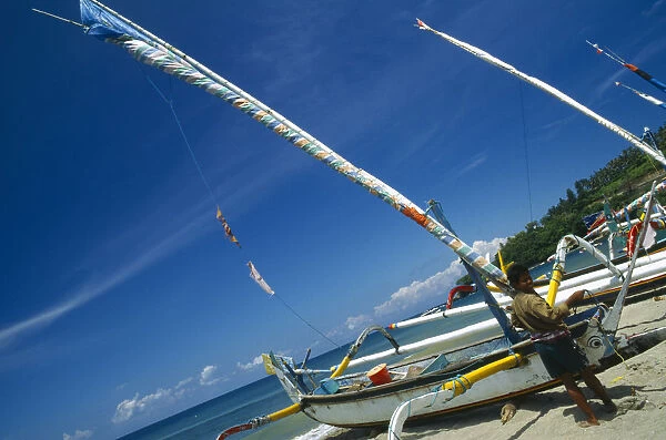 10075619. INDONESIA Lombok Senggigi Outrigger sailboats on the beach with fisherman