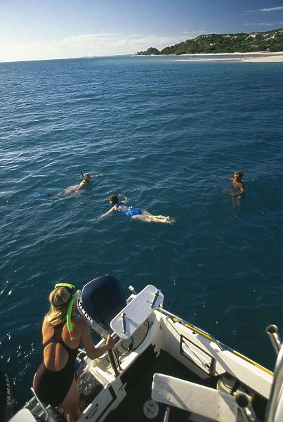 10095604. MOZAMBIQUE Magaruque Island Tourists snorkelling from dive boat