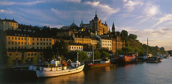 10128086. SWEDEN Stockholm Evening shot of the waterfront area with boats moored