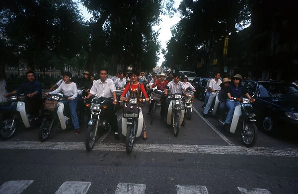 20002336. Vietnam, Hanoi, Rows of motorcycles waiting at junction