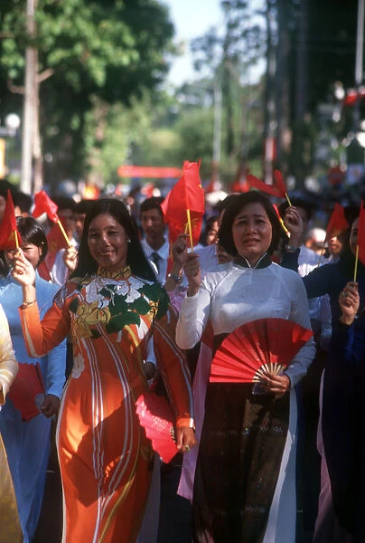 20007612. VIETNAM Ho Chi Minh City Young women holding flags