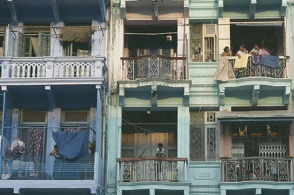 20025884. MYANMAR Yangon Building detail of balconies with hanging washing