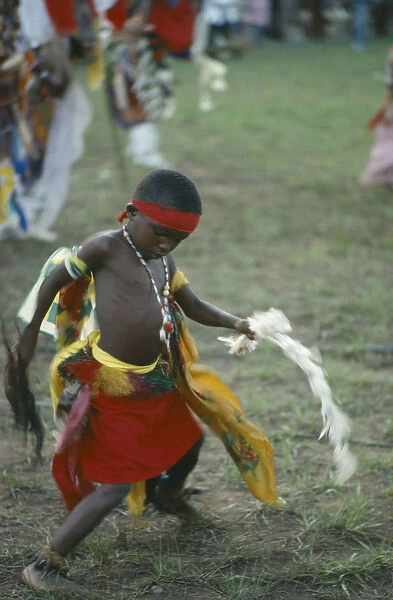 20032554. NIGERIA Festivals Young Igbo boy in traditional dress dancing Ibo