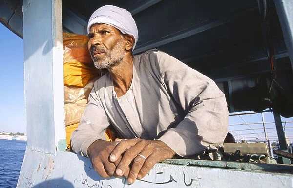 20044084. EGYPT Nile Valley Luxor Man leaning on side of ferry