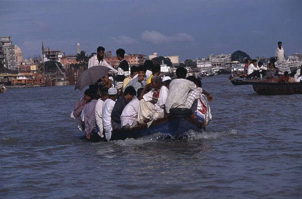 20045595. BANGLADESH Dhaka Overloaded country boat crossing the Buriganga River