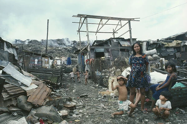 20057432. PHILIPPINES Manila Family on Smoky Mountain slum