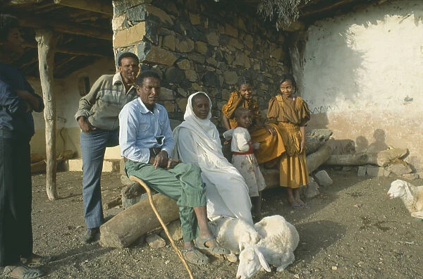 20070845. ERITREA Seraye Province Farming family outside home with sheep
