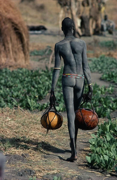 20075255. SUDAN Tribal People Dinka carrying gourds of water to irrigate crops