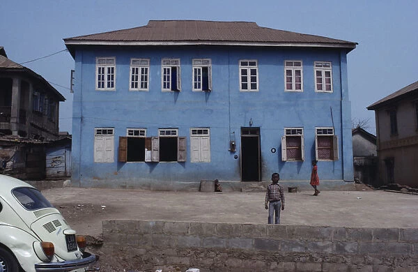 20078321. NIGERIA Inagbiji Blue painted exterior of typical house with wooden shutters