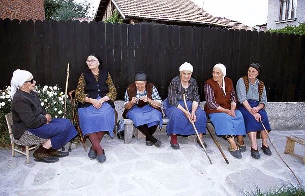 20084094. BULGARIA Bansko Six old ladies sitting on bench