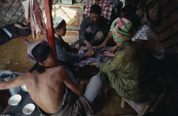 20085609. MONGOLIA People Playing game of dominoes inside yurt