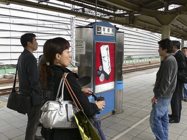 20086607. JAPAN Honshu Tokyo Yurakucho - the smokers spot on the train platform men