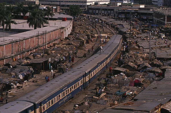 BANGLADESH, Dhaka, Tejgaon Train passing through overcrowded slum housing lining the
