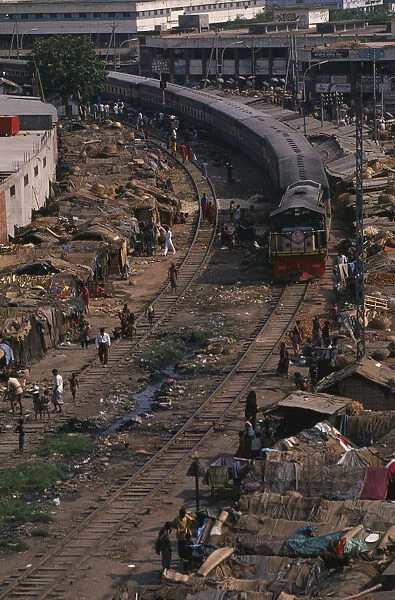 BANGLADESH, Dhaka Train travelling through Tejgoan slum with ramshackle dwellings