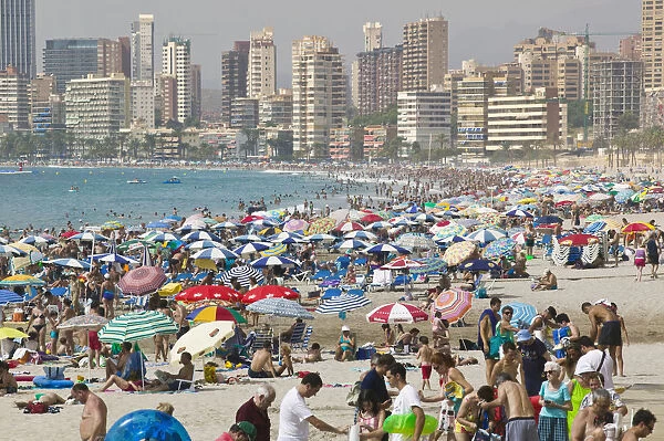 Benidorm. View of crowded beach lined with high rise hotels