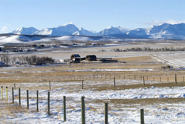 Canada, Alberta, Rockies Farmland south of Magrath and the Rocky Mountains covered in