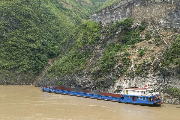 China, Hubei, Three Gorges Barge loading coal from a gravity chute in the Wu Gorge