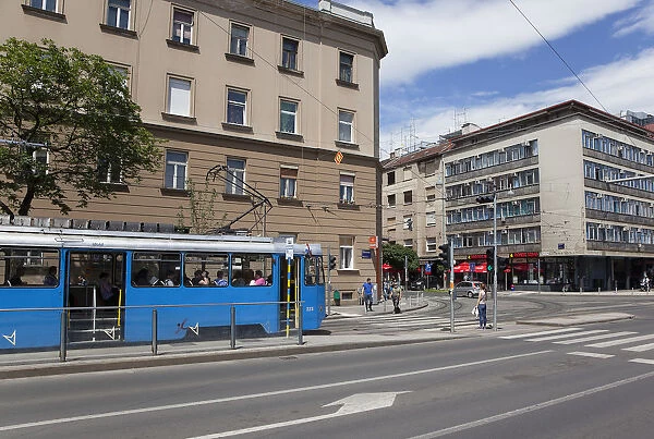 Croatia, Zagreb, Old town, Pedestriasn crossing road with tram waiting