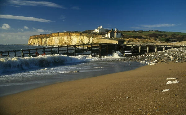 England, East Sussex, Seven Sisters, Cuckmere Haven, View along coastline towards chalk cliff and two hundred year old coastguard cottages built on top of the cliffs