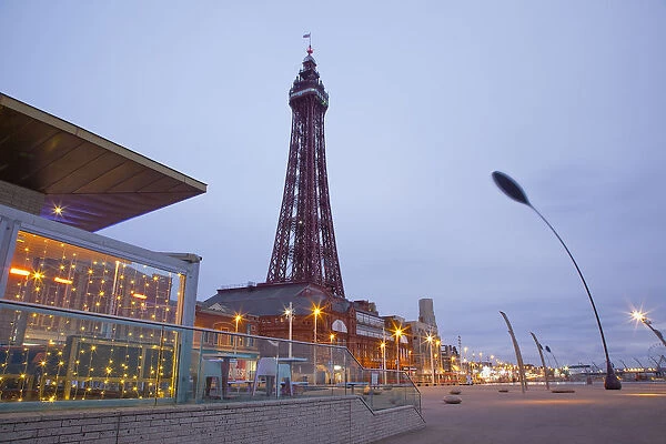 England, Lancashire, Blackpool, Seafront promenade with Tower at dusk