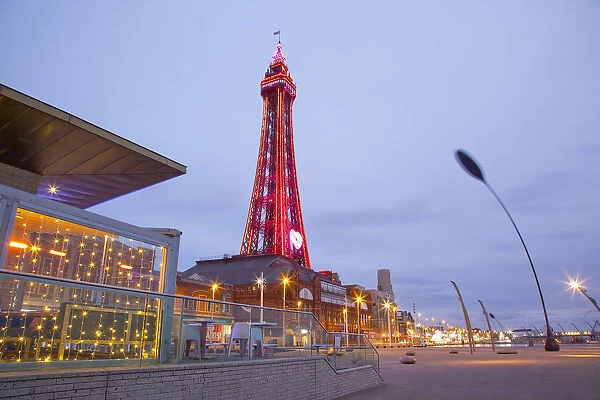 England, Lancashire, Blackpool, Seafront promenade with Tower illuminated at dusk