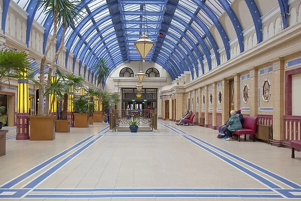 England, Lancashire, Blackpool, Winter Gardens interior with tiled floor, glass roof and palm trees