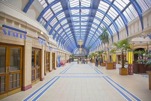 England, Lancashire, Blackpool, Winter Gardens interior with tiled floor, glass roof and palm trees