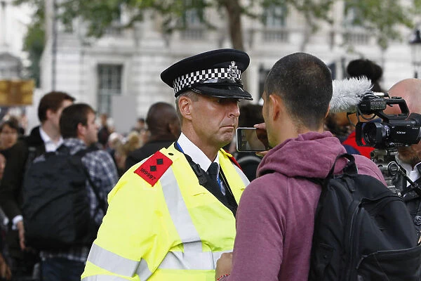 England, London, Westminster, Brexit demonstrations, protestor recording policeman with mobile phone