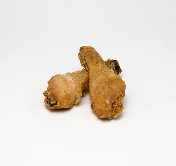 Food, Cooked, Poultry, Two battered chicken drumsticks on a white background
