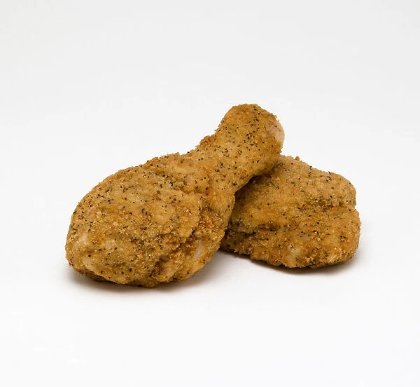Food, Cooked, Poultry, Two breaded chicken drumsticks on a white background
