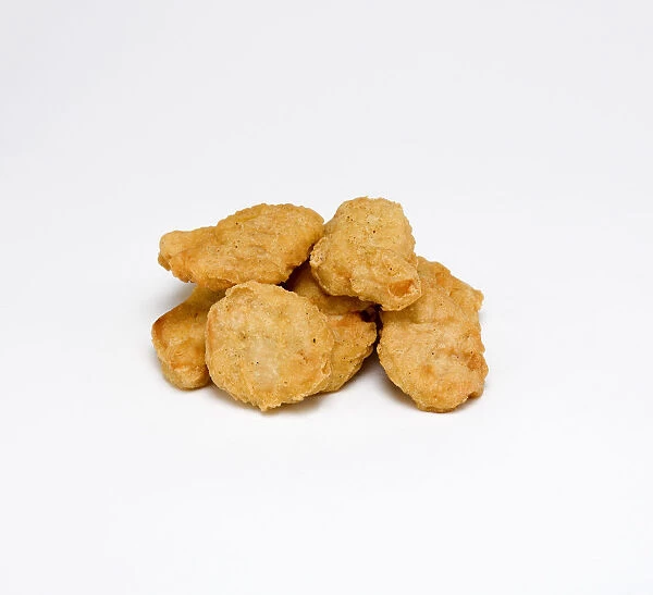Food, Cooked, Poultry, Group of battered chicken nuggets on a white background
