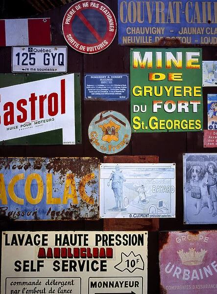 FRANCE, Indre et Loire, Chinon A collection of enamelled advertising signs seen on a