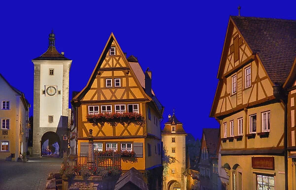 Germany, Bavaria, Rothenburg ob der Tauber, Plonlein or Little Square by night flanked by the Siebers Tower and the Kobolzeller tower