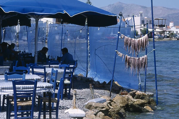 GREECE, Peloponnese, Elafonisos Restaurant outside seating with blue table