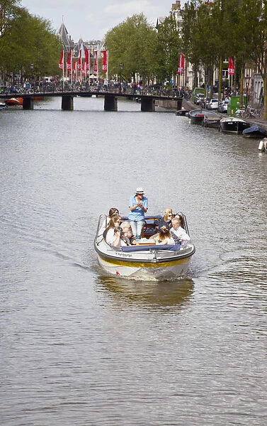 Holland, North, Amsterdam, Tourists on canal tour boats